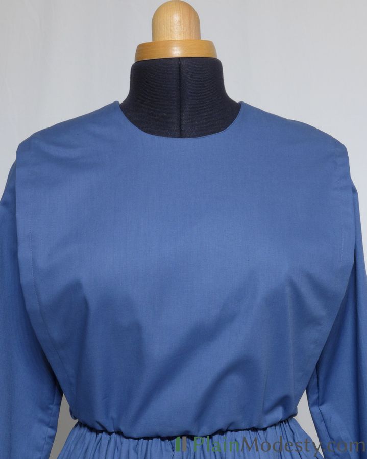 Cape Dress Front View Front view of a cape dress with a Narrow, Straight, Gathered cape