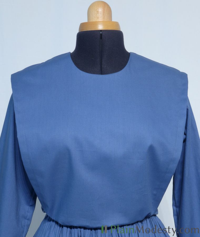 Cape Dress Front View Front view of a cape dress with a Wide, Slanted, Gathered, Loose, Tapered cape